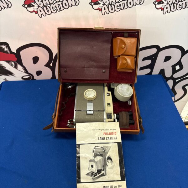 Vintage Polaroid 160/800 Land Camera in a worn condition.