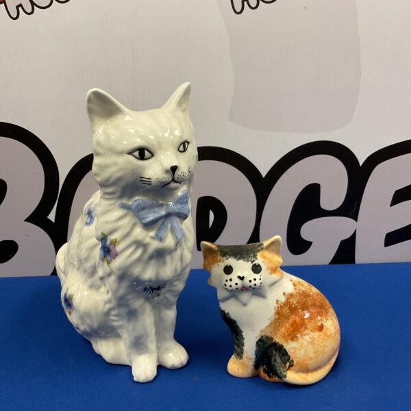 Vintage porcelain cat ornaments, a charming collectible pair.