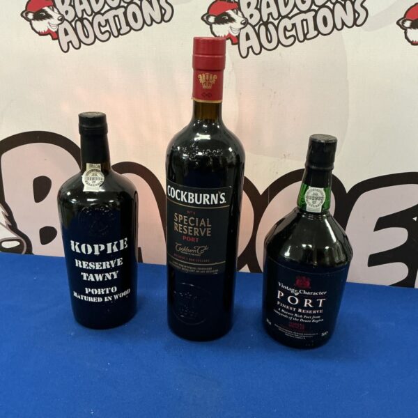 Collection of three Port wine bottles including Cockburns and Kopke.