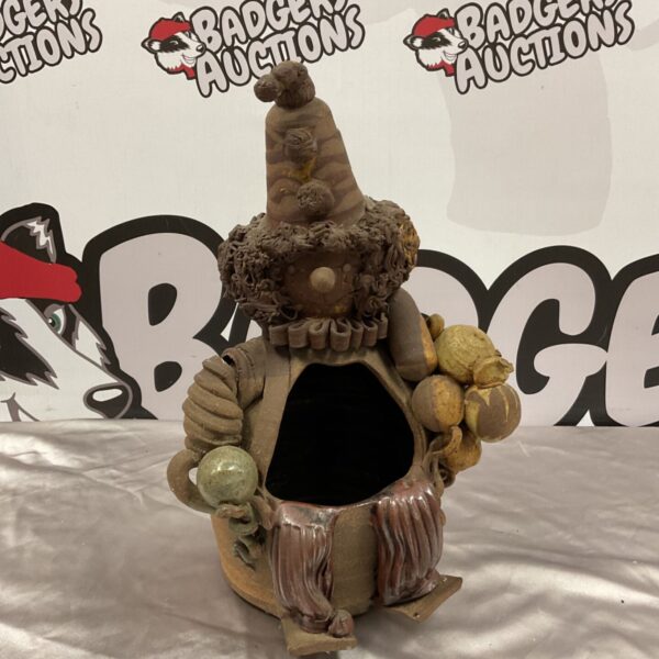 Hand-modelled pottery clown salt pig with conical hat and open front
