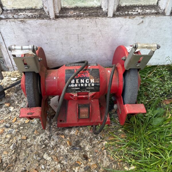 Vintage Power Devil bench grinder in red, a classic workshop tool.