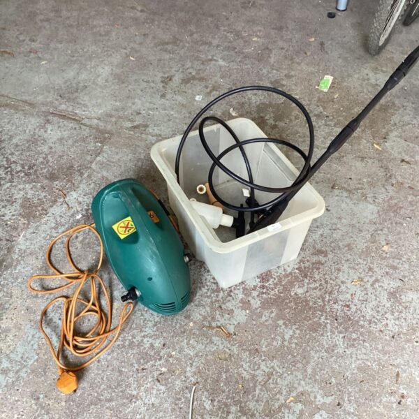 Power washer with attachments for garden and driveway cleaning.