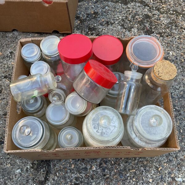 Large lot of vintage preserve jars for canning and storage.