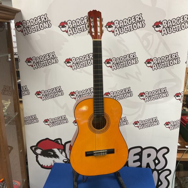 Prince C 425 acoustic guitar with natural orange finish and six tuning pegs
