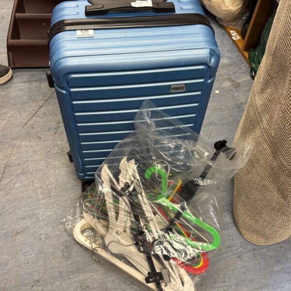 Blue Princess Traveller hard-shell suitcase beside a bag of hangers