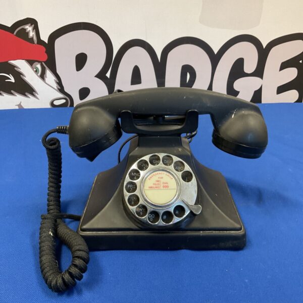 Black vintage Protlex Ren 1 rotary telephone on a surface.