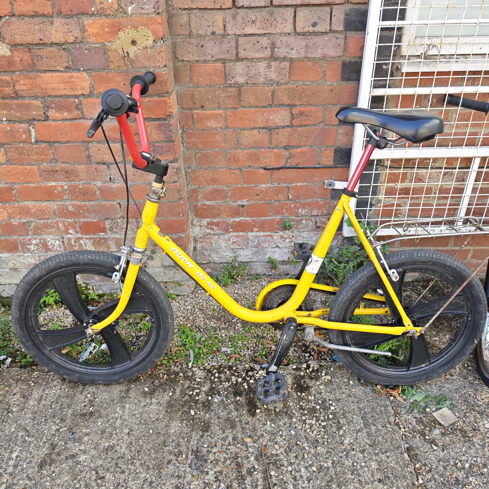 Yellow Puch Pic-nic bicycle with unique wheel design.