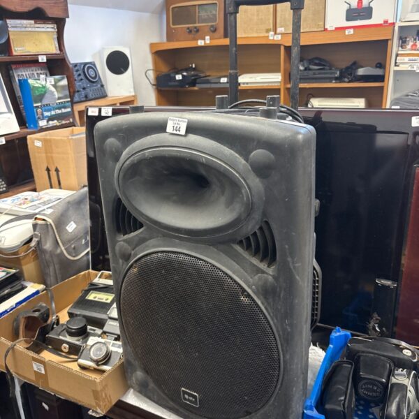 QTX portable PA speaker in used condition, side view.