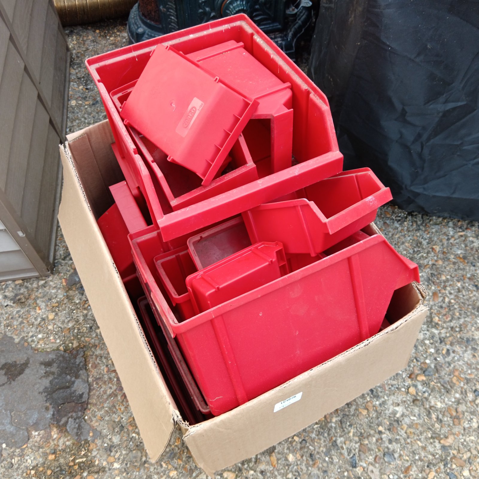 Red Raaco workshop trays stacked inside a cardboard box.