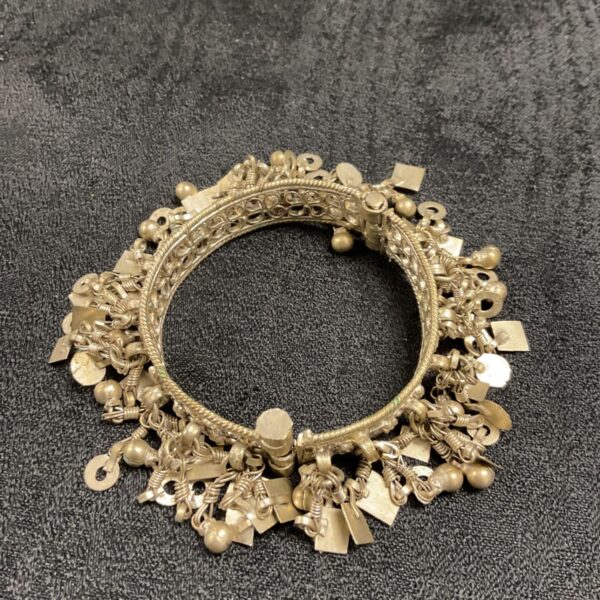 Antique Rajasthan silver bangle with decorative drops.