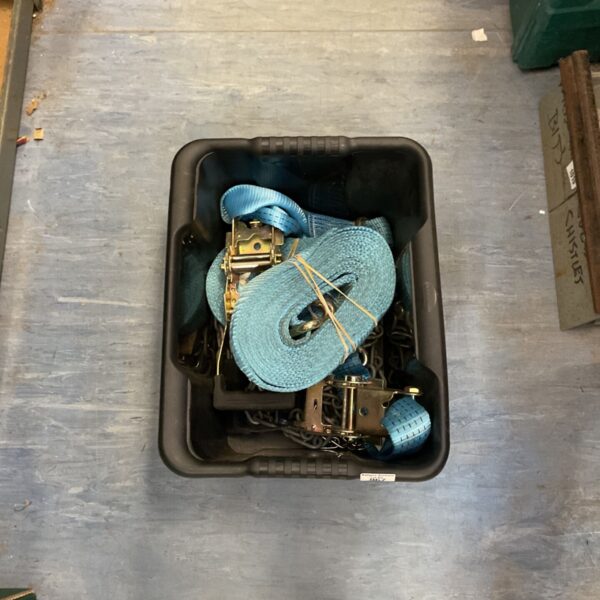 Blue ratchet tie down straps with chain sections in a plastic bin.