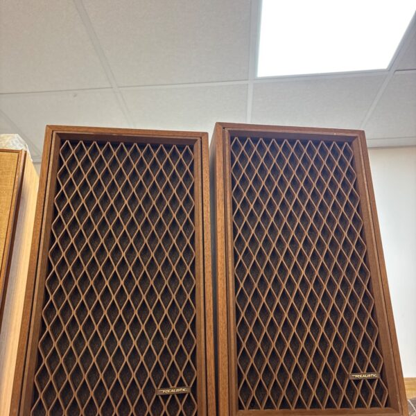 Pair of vintage Realistic Nova-Five bookshelf speakers in woodgrain.