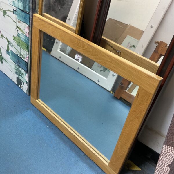 Rectangular oak framed wall mirror with natural honey finish and moulded lower edge