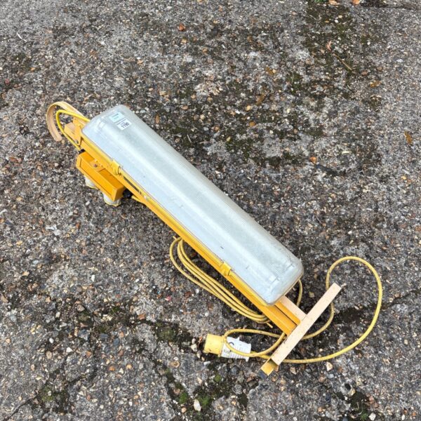 Red Arrow Weatherguard LED work light on a grey surface.