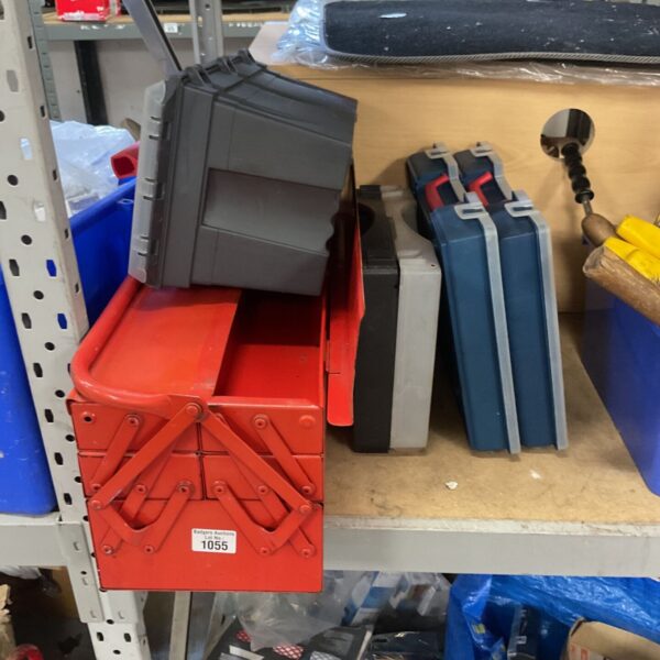 Red metal cantilever tool box with grey and blue plastic tool boxes beside it