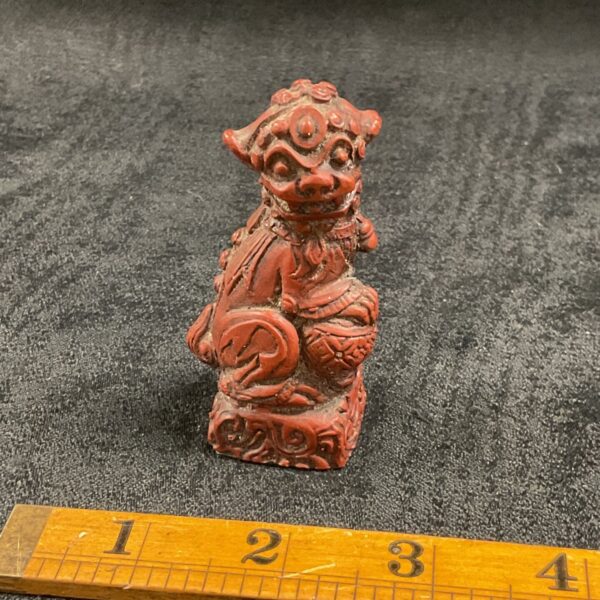 Detailed red Chinese Foo Dog statue, a traditional guardian lion.