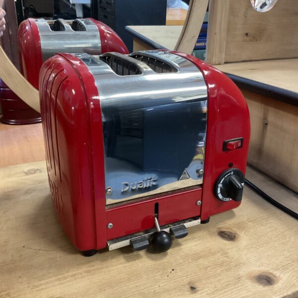 Red Dualit two slice toaster with polished metal front panel and browning dial