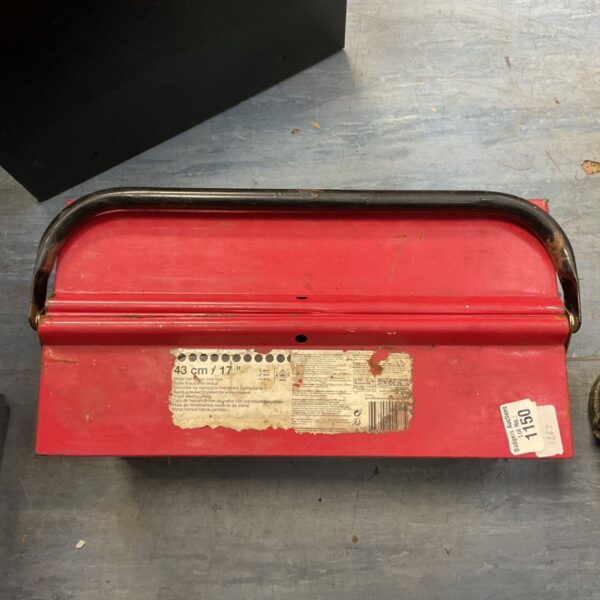 Red metal cantilever toolbox with visible wear and tear.