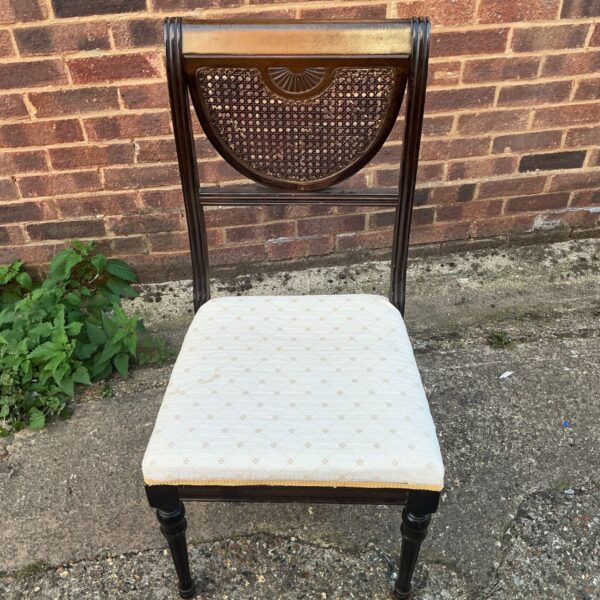 Antique Regency style chair with patterned upholstery and curved back.