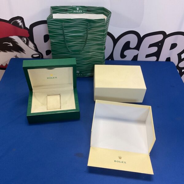 Empty Rolex watch box with outer bag, luxury presentation.
