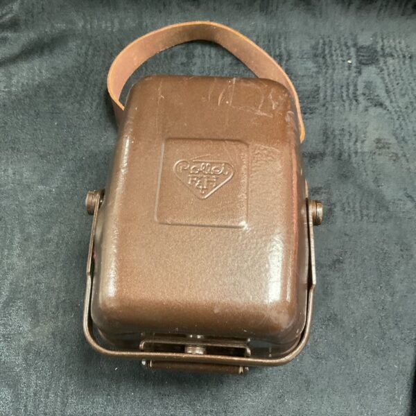 Brown metal Rollei F&H tropical camera case with leather strap, front view