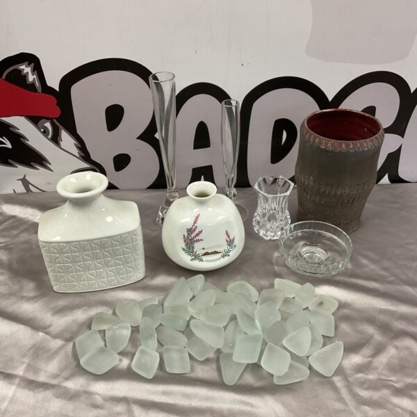 Mixed lot of white ceramic vases, glassware and frosted glass stones on satin cloth