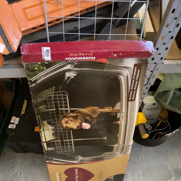 Rosewood dog car guard in original packaging, showing signs of wear.