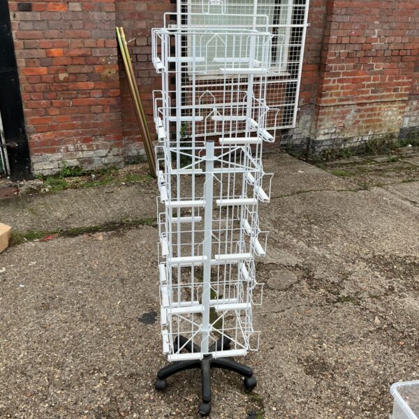 Vintage rotating card stand with black base for shop displays.