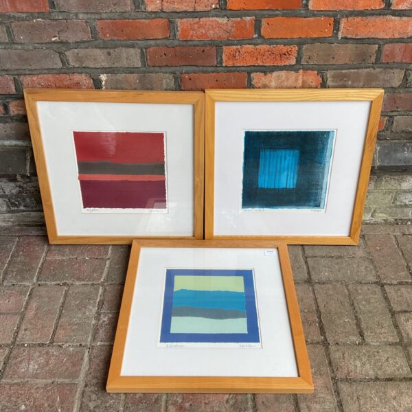 Red and black abstract Roy Speltz art print in a frame.