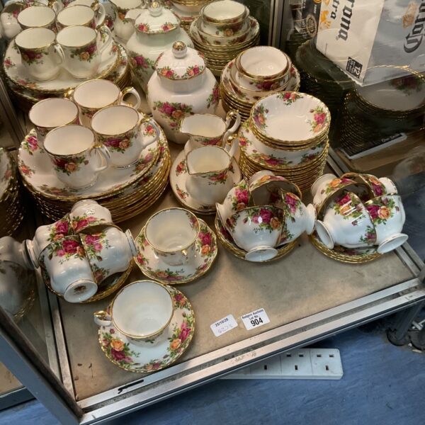 Large Royal Albert Old Country Roses dinner service laid out on a display table