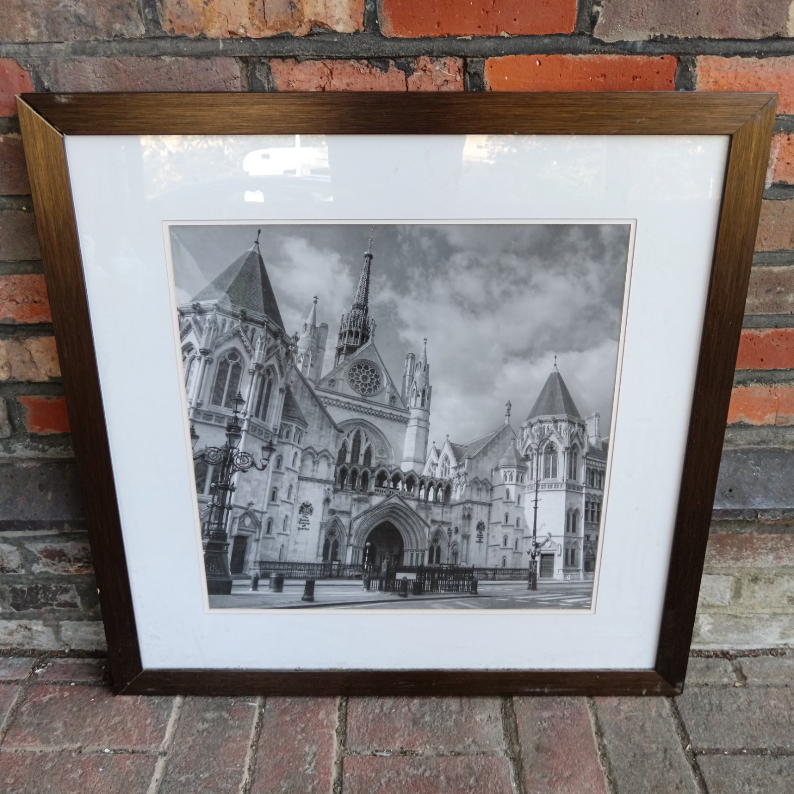 Framed black and white photograph of the Royal Courts of Justice in London.