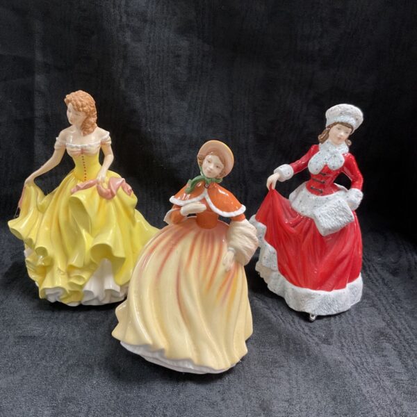 Royal Doulton Pretty Ladies figurines in yellow, orange and red.