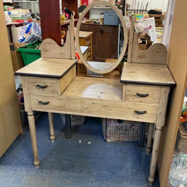 Rustic wooden dressing table with mirror and drawers.