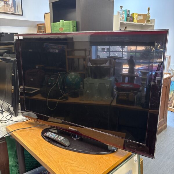Samsung 46 inch flat screen TV with remote control.
