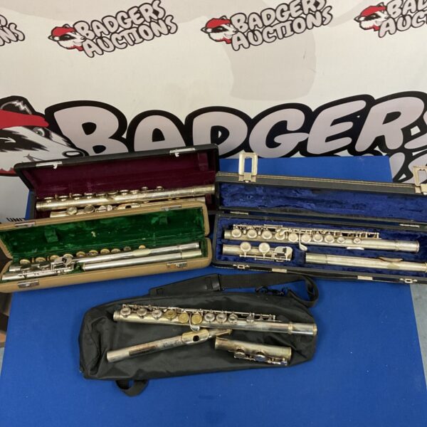 Lot of four flutes in cases, including a Sapphire flute, on display