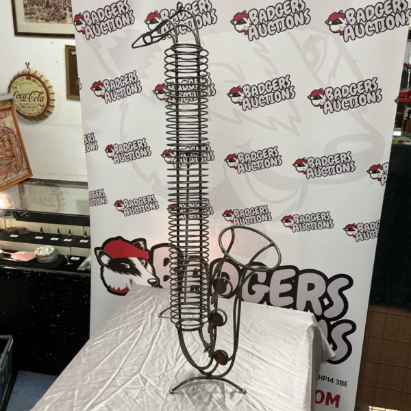 Metal wire saxophone-shaped CD rack with coiled spiral body and ball feet