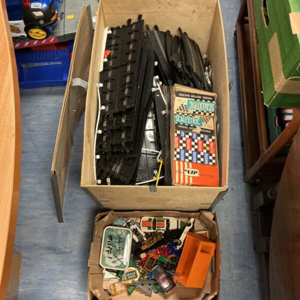 Large box of Scalextric slot car track with vintage cars and model racing items