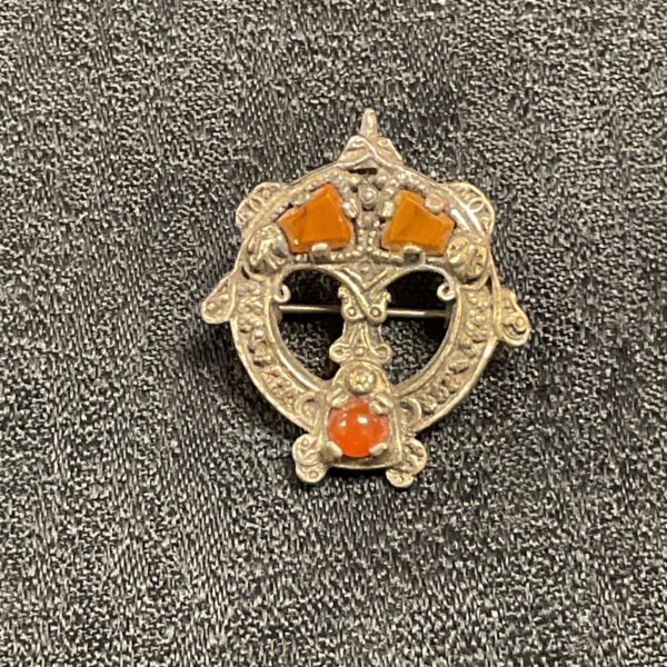 Antique Scottish silver brooch with orange stones.