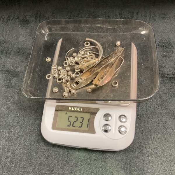 Close-up of 52.31g scrap silver lot with various components.