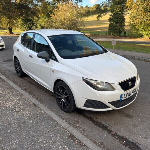 White Seat Ibiza parked on a street.