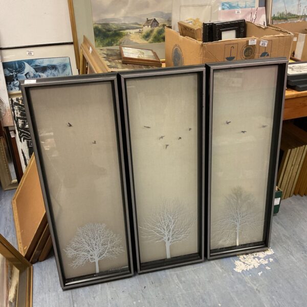 Set of three black framed wall art panels with winter tree silhouettes and birds