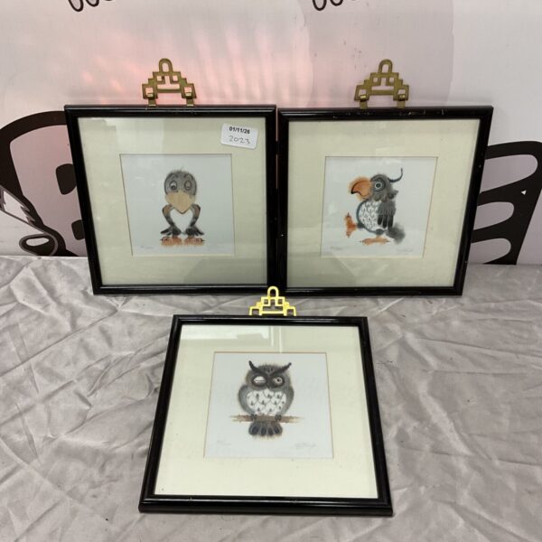 Set of three framed satirical bird prints with black frames and cream mounts
