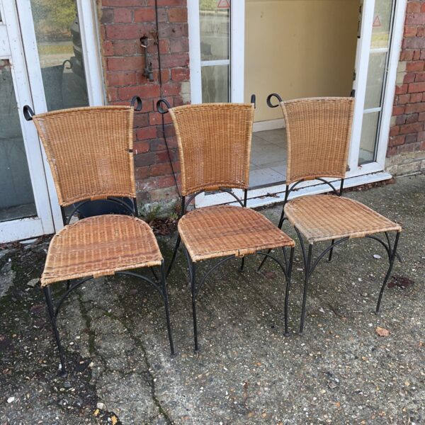 Set of three metal framed chairs with woven wicker backs and seats