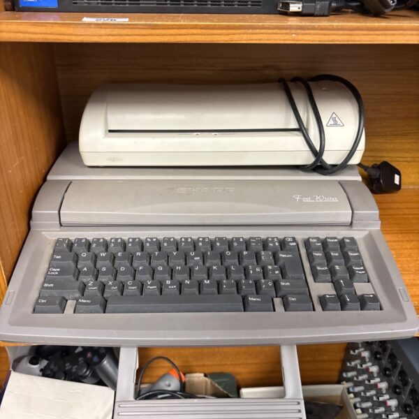 Vintage Sharp word processor with thermal laminator, 1980s office technology.