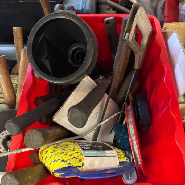 Shed clearance tool lot with nylon rope and various hand tools.