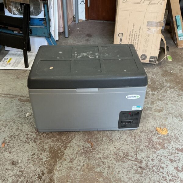 Grey Shoreline plug in cool box with black lid on concrete floor