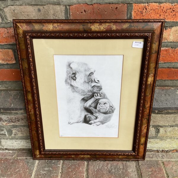 Signed black and white print of adult gorilla holding baby gorilla in brown frame