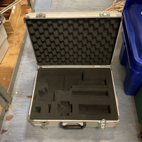 Silver aluminium flight case with black foam interior, open for viewing.