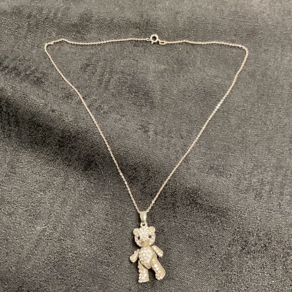 Sparkling silver bear pendant necklace with white stones.