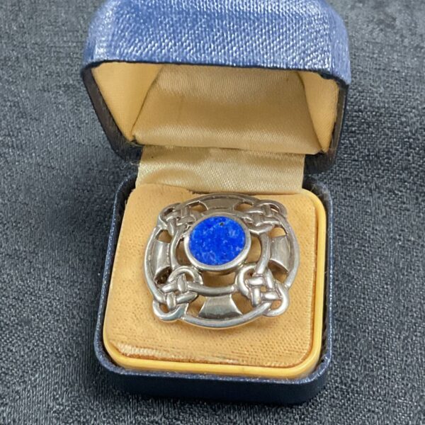 Antique silver Celtic knot brooch with a vibrant Bluestone.